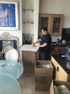 Man wrapping glasses for transport